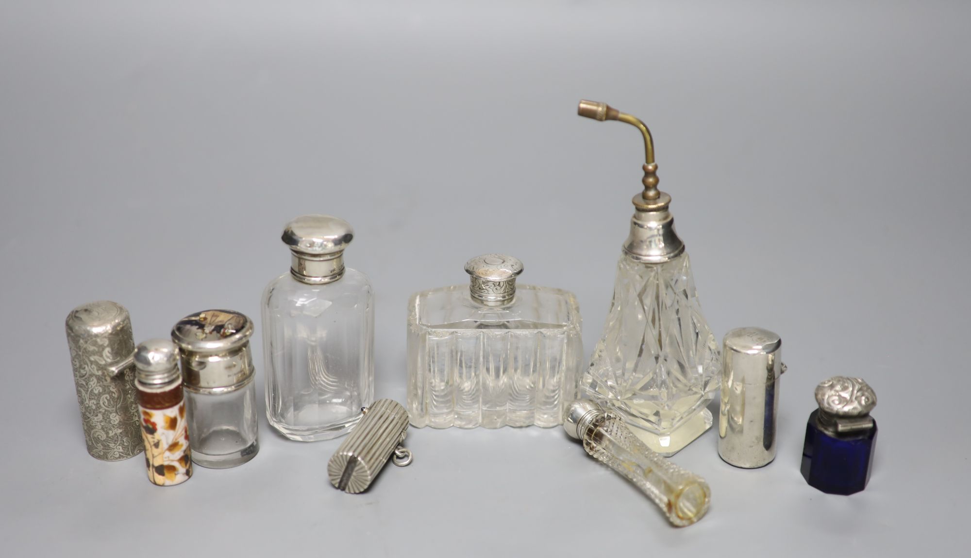 A Victorian cylindrical silver scent bottle by Sampson Mordan & Co, London, 1882, 54mm (a.f.), 8 others and a vest case.